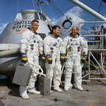 Apollo 10 astronauts in space suits in front of Command Module