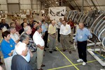 KENNEDY SPACE CENTER, FLA. - The Stafford-Covey Return to Flight Task Group (SCTG) inspects debris in the Columbia Debris Hangar. At right is the model of the left wing that has been used during recovery operations. Chairing the task group are Richard O. Covey, former Space Shuttle commander, and Thomas P. Stafford (third from right, foreground), Apollo commander. Chartered by NASA Administrator Sean O’Keefe, the task group will perform an independent assessment of NASA’s implementation of the final recommendations by the Columbia Accident Investigation Board.