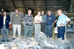 KENNEDY SPACE CENTER, FLA. - In the Columbia Debris Hangar, members of the Stafford-Covey Return to Flight Task Group (SCTG) inspect some of the debris. Chairing the task group are Richard O. Covey, former Space Shuttle commander, and Thomas P. Stafford (fourth from left), Apollo commander. Chartered by NASA Administrator Sean O’Keefe, the task group will perform an independent assessment of NASA’s implementation of the final recommendations by the Columbia Accident Investigation Board.