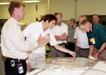 KENNEDY SPACE CENTER, FLA. - NASA worker Joy Huff (right) shows a leading edge subsystems (LESS) with tile bonded to it to members of the Stafford-Covey Return to Flight Task Group (SCTG). From left are Dr. Amy Donahue, David Lengyel, Dr. Kathryn Clark, Richard Covey, former Space Shuttle commander, and William Wegner. Covey is co-chair of the SCTG along with Thomas P. Stafford, Apollo commander. Chartered by NASA Administrator Sean O’Keefe, the task group will perform an independent assessment of NASA’s implementation of the final recommendations by the Columbia Accident Investigation Board.